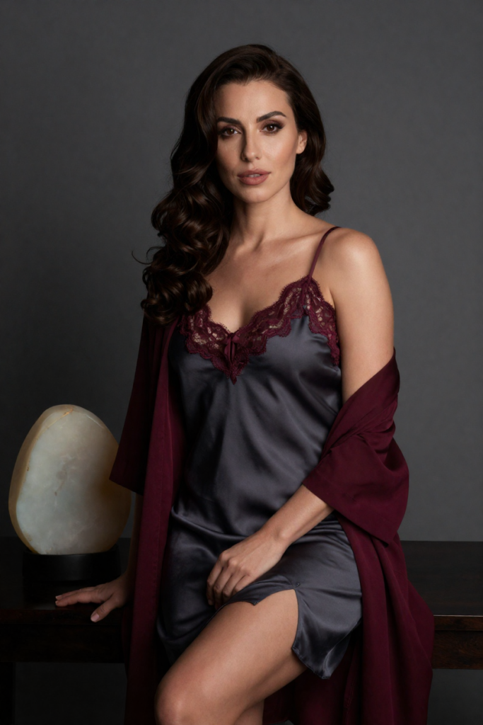 HuarenAu muse in a charcoal silk slip dress beside a plain polished opal stone